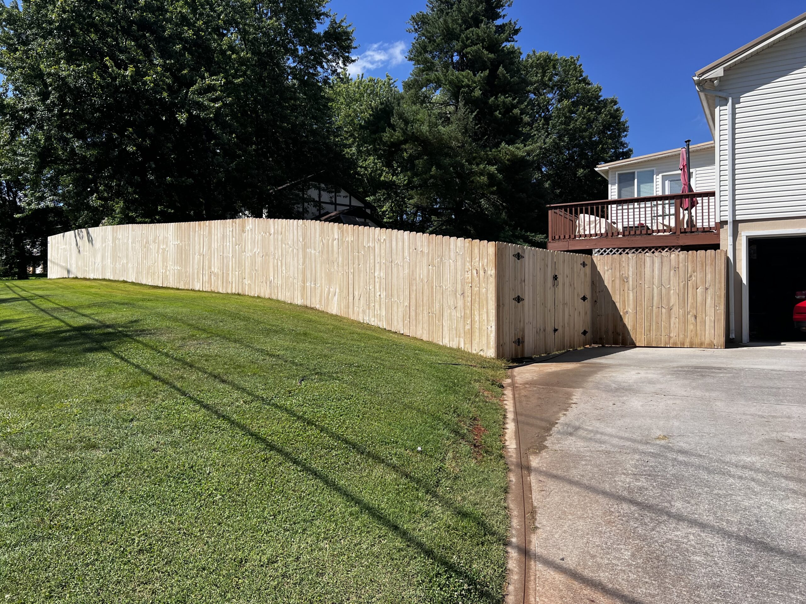 A freshly installed wooden privacy fence along the residential property.